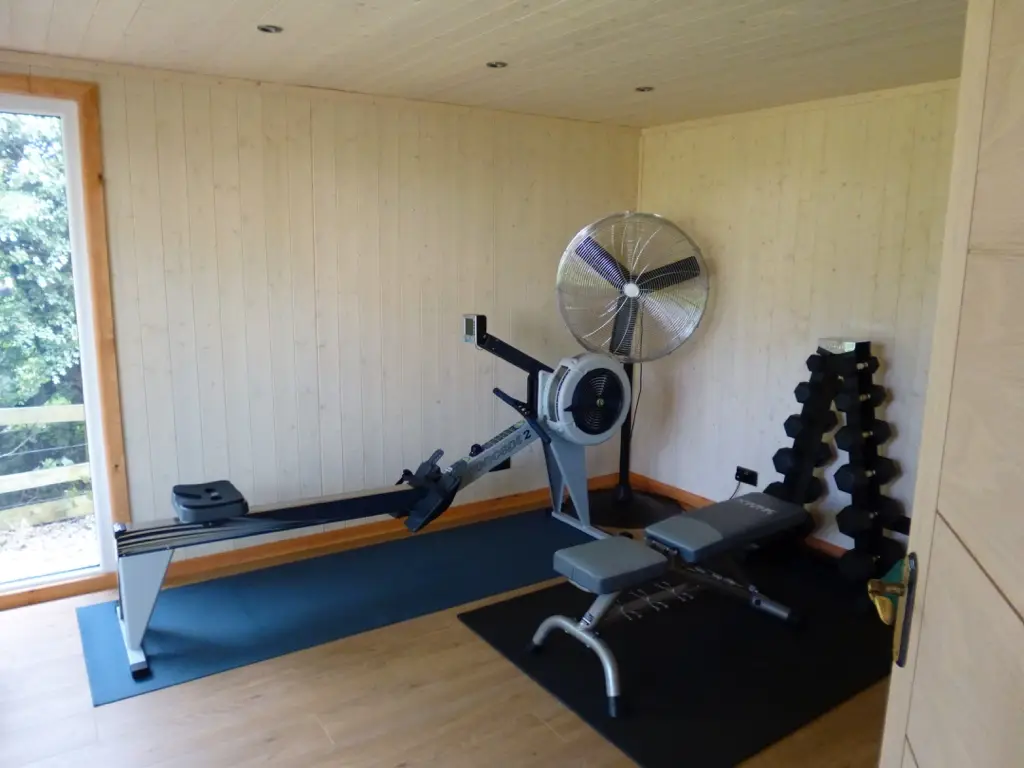 western red cedar home gym interior photo THIS IS A BESPOKE SUMMERHOUSE BUILT BY LANCASHIRE SUMMERHOUSES