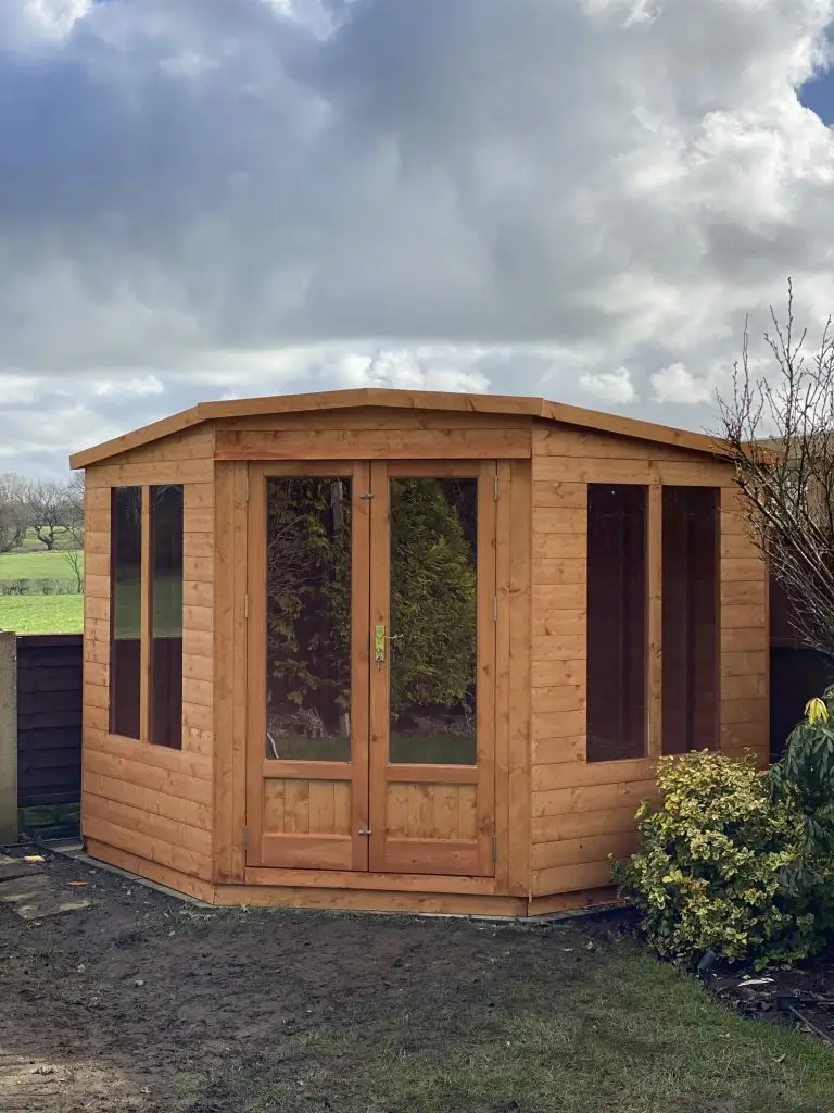 APEX SHAPE CORNER SUMMERHOUSE WITH FIRESTONE RUBBER ROOF BY LANCASHIRE SUMMERHOUSES