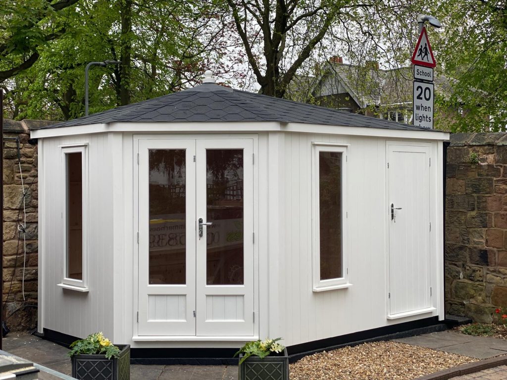 Lancashire Summerhouses-CUSTOM MADE - BESPOKE -CONTEMPORARY CORNER SUMMERHOUSE PAINTED IN WHITE WITH A BLACK FELT TILED ROOF AND A BUILT IN STORE ASSEMBLED IN LIVERPOOL